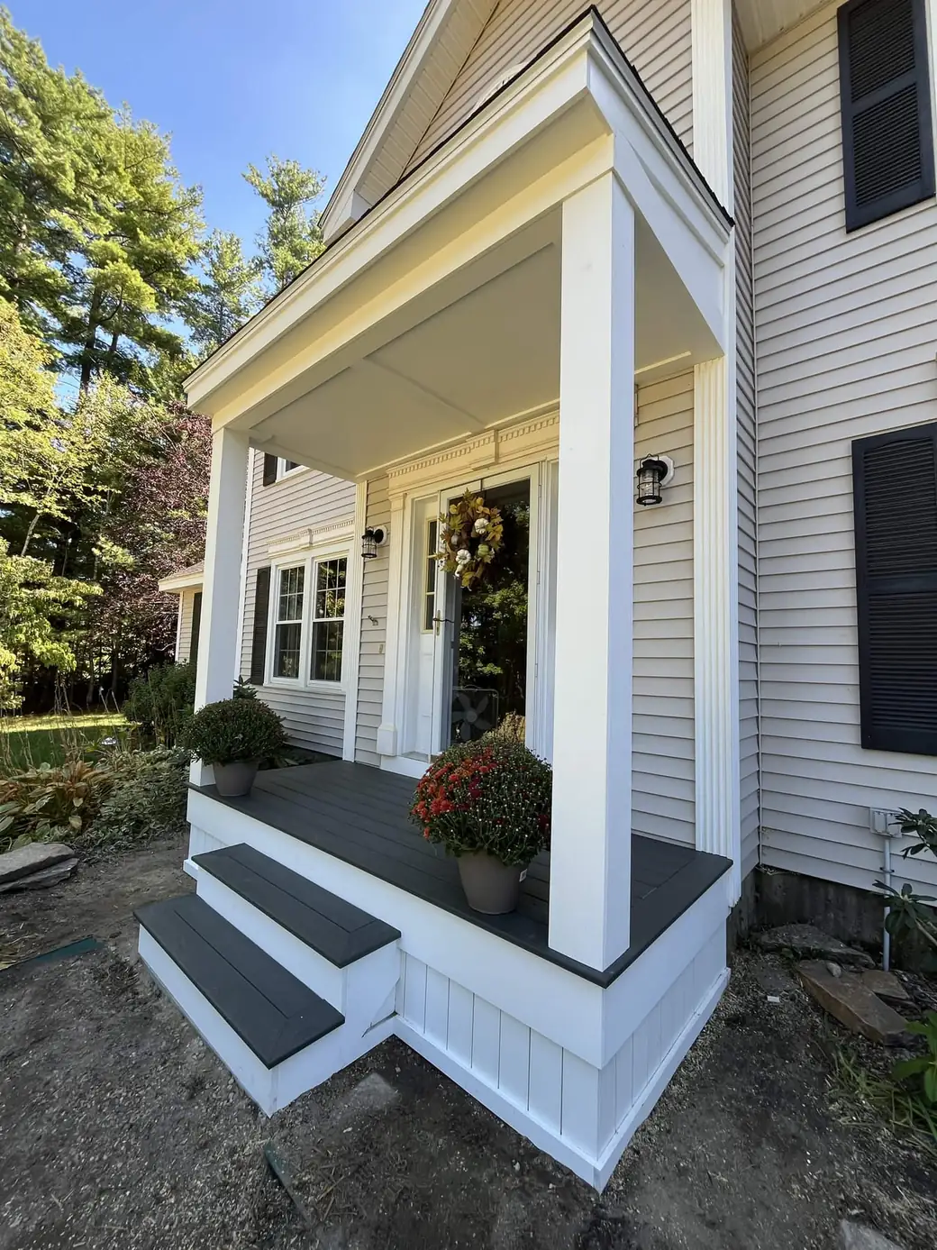 Angled view of a portico roof, fluted columns and mitred trim returns