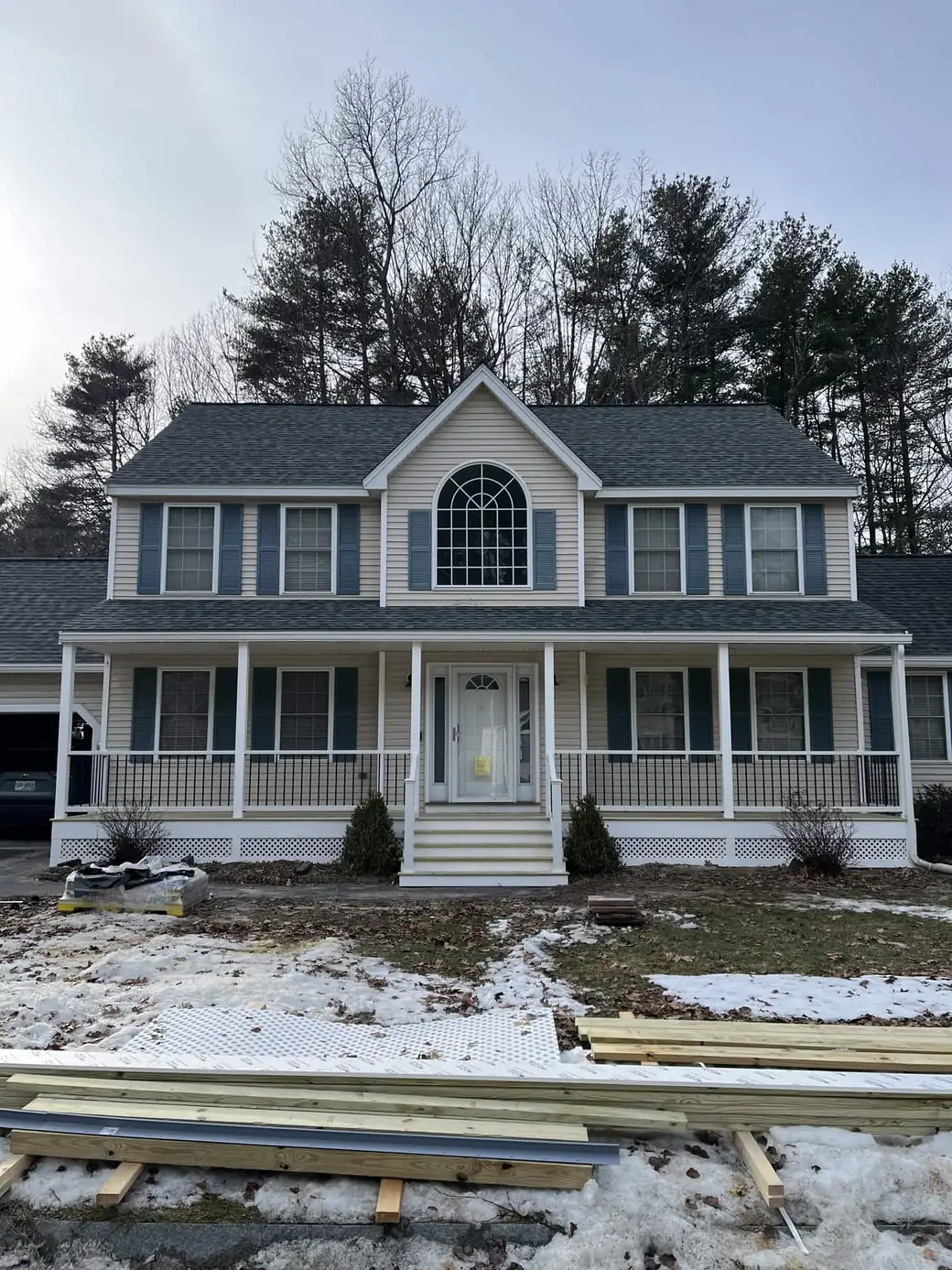Full-width farmer's porch on a colonial with a Palladian window above the entry